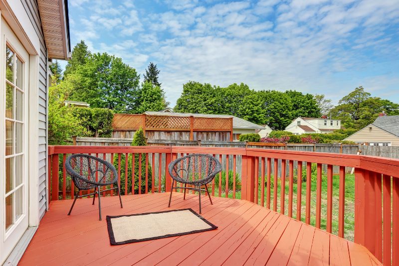 cozy deck painted red with railing