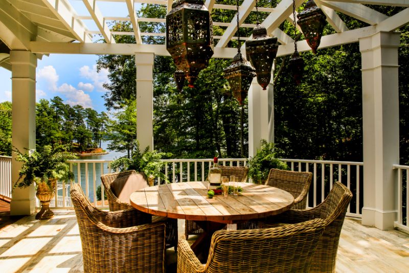 cozy pergola with potted plants at a lakefront