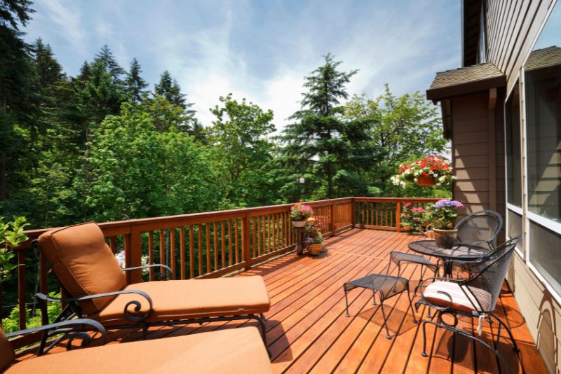 beautiful timber deck with seating and potted plants